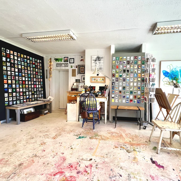 Bildet viser atelieret til kunstner Ingrid Andenæs Tronstad, som har malt mange miniatyrbilder som henger på vegg og på større plater i rommet.
